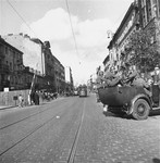 German police relax in a vehicle at the gate to the Warsaw ghetto on Leszno Street.