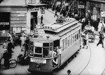 A streetcar turns through the intersection of Leszno and Karmelicka Streets in the Warsaw ghetto.