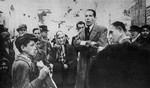 The famous opera singer, Dotlinger, performs on the street in the Warsaw ghetto.