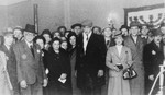 Jewish council chairman Mordechai Chaim Rumkowski, poses with a group of people at a ceremony in the Lodz ghetto.