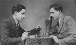 Two Jewish brothers play a game of chess in their home in Tomaszow Lubelski, Poland.