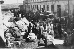 Jews stand among piles of household possessions while waiting to move into the Lodz ghetto.