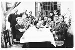 The extended Krasso and Spitzer families pose outside around a table at a family gathering shortly before the start of the war.