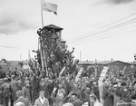 Survivors in Allach, a sub-camp of Dachau, greet arriving U.S.