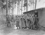 Survivors in the Ampfing concentration camp stand outside of the "camp infirmary."