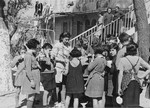 Jewish refugee children interned at the Hotel Bompard are fed by Margot Stein, a relief worker.