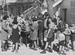 Jewish refugee children interned at the Hotel Bompard are fed by Margot Stein, a relief worker.