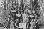 A priest and several nuns pose with a group of children at a Franciscan convent school in Lomna, Poland where Jewish children were hidden during the German occupation.