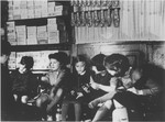 Children try on shoes in the Jewish owned Erlanger shoe and dry goods store in Guntersblum, Germany.