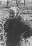 Portrait of an elderly Jewish woman standing in the garden of her farm.