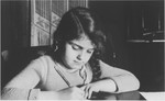 A young Jewish girl, Ann Hellman, writes her lessons at her home in Guntersblum, Germany.