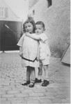 Two young Jewish siblings pose in the courtyard of their home in Guntersblum, Germany.