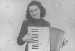 A young Jewish woman, Florica Kabilio, playing her accordion.