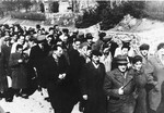 Jews from the Neustadt displaced persons camp, some wearing concentration camp uniforms, march to a memorial service.