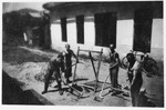 Four Jewish prisoners work outside a barracks in a Slovak labor camp.