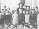 Jeanne Daman (center) poses with Jewish children under her care in the Nos Petits kindergarten.