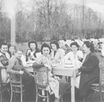 Belgian rescuer, Jeanne Daman and other teachers eat outside [probably in the Nos Petitis kindergarten.]