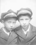 Close-up portrait of Yehuda (Yulik) and Israel (Srulek) Dubner wearing their school caps.