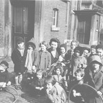 Jeanne Daman (center) poses with Jewish children under her care in the Nos Petits kindergarten.