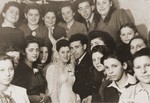 A Jewish bride and groom pose with their family and friends in the Neu Freimann displaced persons camp.