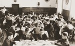 The children eat a meal in the dining room of the Baruch Auerbach Jewish orphanage in Berlin.