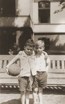 Two young boys pose with a ball in the yard of the Baruch Auerbach Jewish orphanage in Berlin.