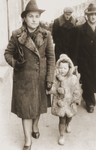 Stefa Friedfertig walks down a street in Katowice with her "mother", Maria Amborski prior to her return to her real mother.