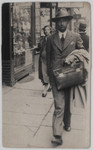 Benedykt Lusthaus (uncle of the donor), a botony 
professor at the University of Lodz, walks down a street carrying a briefcase.