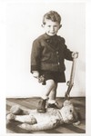Portrait of Otto Littman, the son of Izio and Anda Littman, holding a toy rifle.