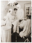 Dr. Karoly Haszler performs surgery in the Foehrenwald displaced persons camp.