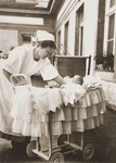 A German nursemaid lays the infant Inge Marx in her bassinet.