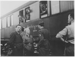 OSE official, Joseph Weill (left), and Dr. G. Revel (center) greet the Buchenwald children's transport upon its arrival in the Les Andelys train station.