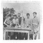 Ivar Segalowitz and three other boys display models that they made in a woodworking class in the Ecouis children's home.
