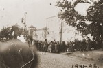 German guards oversee the assembly of Jews in Kamenets-Podolsk prior to their transportation to a site outside of the city for execution.