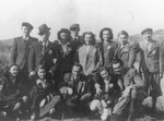 A group of young people pose for a group portrait wearing yellow stars shortly before they were sent to a ghetto.