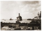 The Exodus 1947 limps into the port of Haifa after being battered by British destroyers during its interception at sea.