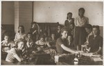 Sewing workshop in the Sosnowiec ghetto.  

Seated in the middle is Hinda Chilewicz.
