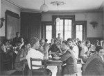Residents of the Hôme de la Forêt children's home eat a meal in the dining hall.