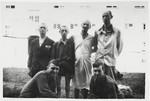 Four survivors of Dachau and Buchenwald pose with Pfc.