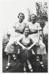 Magda Grunfeld poses in a garden with her two cousins.