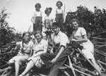 Members of the extended Saleschütz family pose on a pile of wood in Kolbuszowa.
