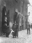 A Jewish woman carries a goose along a street in the Kazimierz quarter of Krakow.