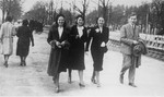 Four Jewish friends walk through a park in Krakow.