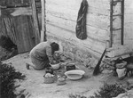 Jewish woman cleaning pots near her house in Kazimierz Dolny.