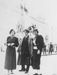 Three young Jewish men and women pose on a street in Krakow during a vacation.