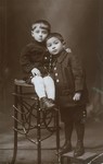 Studio portrait of two Jewish cousins in Vilna.

Pictured are Szepsel Kaftanski (left) and his cousin Alter Goldstein.
