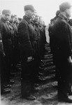 Jewish police in the Westerbork transit camp stand in formation during a roll call.