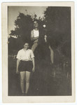 A young man on a horse poses next to his girlfriend in Kibbutz Gan Shmuel.