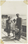 An Austrian Jewish family poses on a walkway next to the shore.