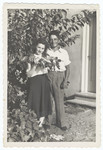 Close-up portrait of a young couple standing next to a tree in a garden of Kibbutz Gan Shmuel.